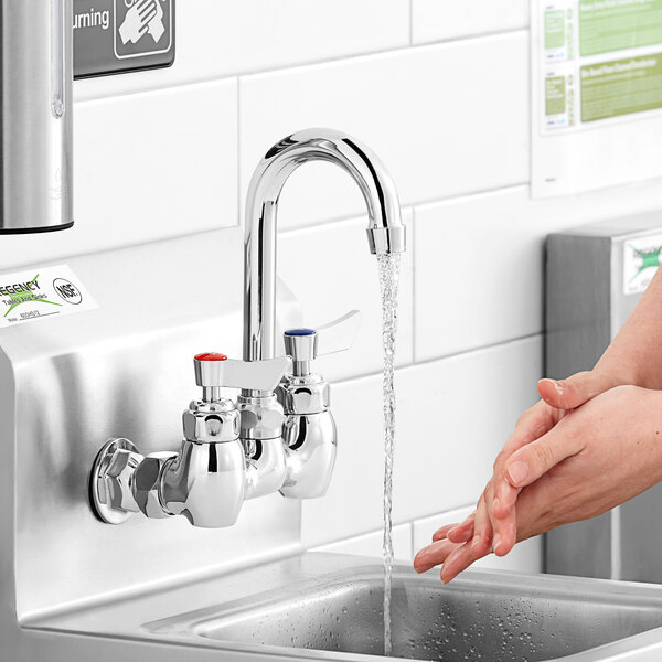A person using a Waterloo Replacement Ceramic Faucet Cartridge Repair Kit to wash their hands under a sink.