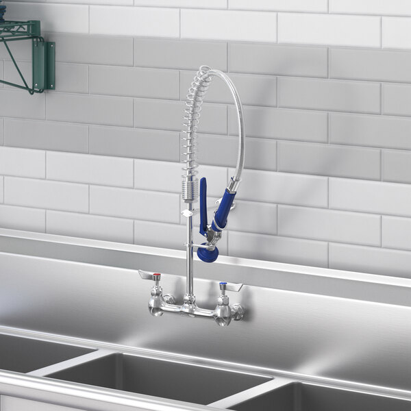 A sink with a Waterloo pre-rinse spray valve and a faucet hose.