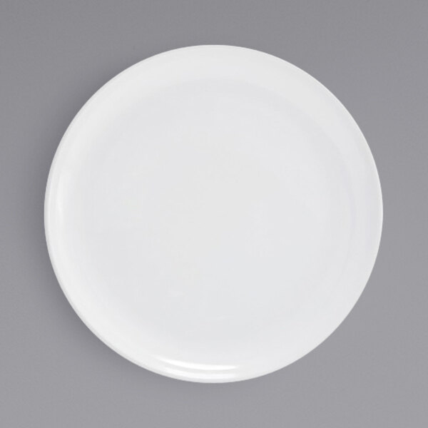 A Front of the House bright white porcelain plate with a white rim on a gray background.