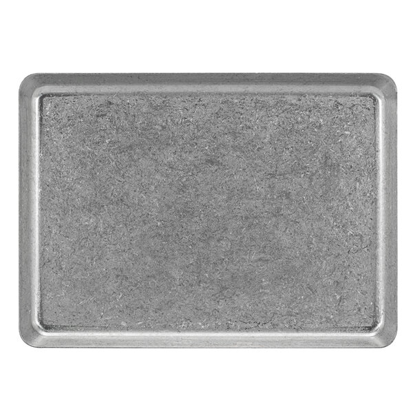 A close-up of a rectangular Front of the House stainless steel plate with an antique finish.