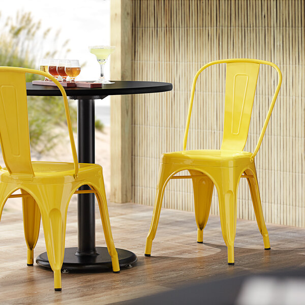 Lancaster Table & Seating Alloy Series Yellow Metal Indoor / Outdoor Industrial Cafe Chair with Vertical Slat Back and Drain Hole Seat