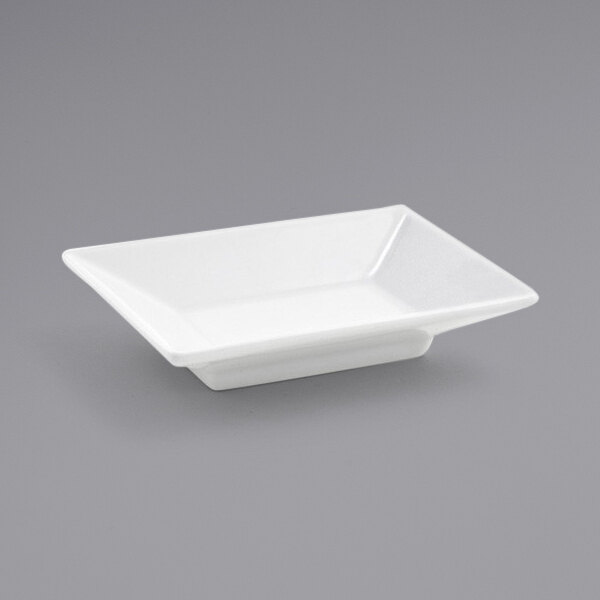 A white rectangular Front of the House Kyoto sauce dish on a gray surface.