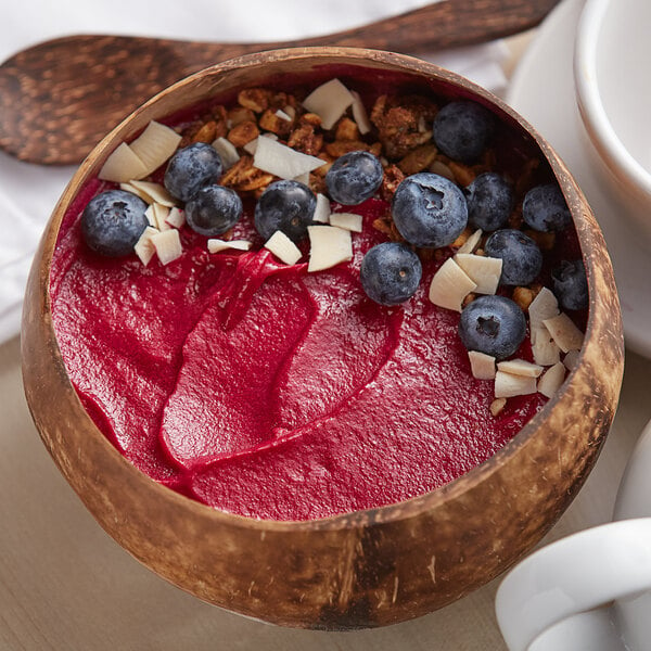A bowl of Acai Roots pitaya sorbet with blueberries and granola.