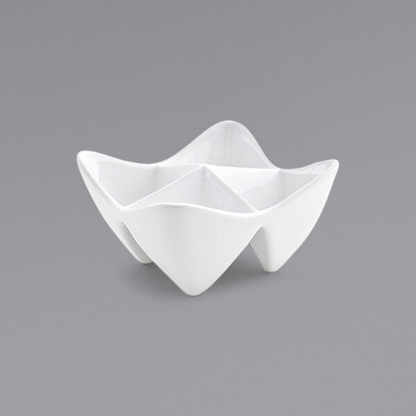 A white porcelain bowl with 4 triangle-shaped sections.