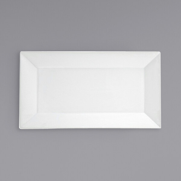 A white rectangular porcelain platter with a white border on a gray surface.