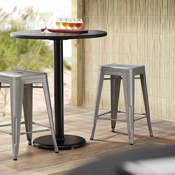 Lancaster Table & Seating Alloy Series Silver Stackable Metal Indoor / Outdoor Industrial Cafe Counter Height Stool with Drain Hole Seat