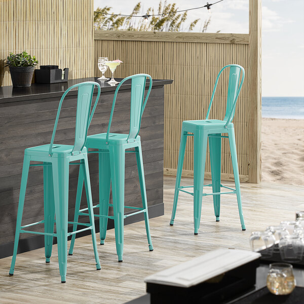 Lancaster Table & Seating Alloy Series Seafoam Metal Indoor / Outdoor Industrial Cafe Barstool with Vertical Slat Back and Drain Hole Seat
