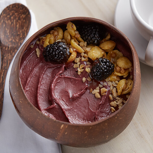 A bowl of Acai Roots unsweetened acai berry puree with berries and nuts.
