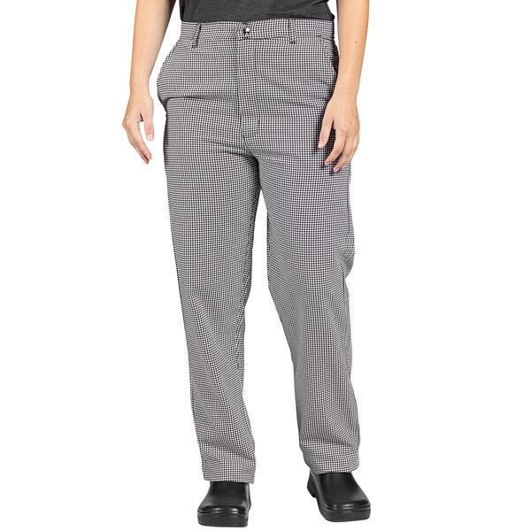 A woman wearing Uncommon Chef black and white houndstooth chef pants.