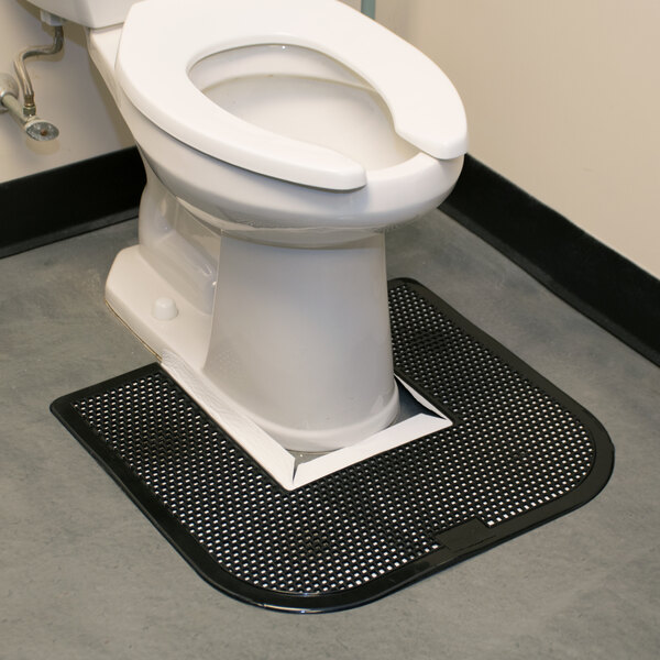 A toilet with a black disposable toilet floor mat.