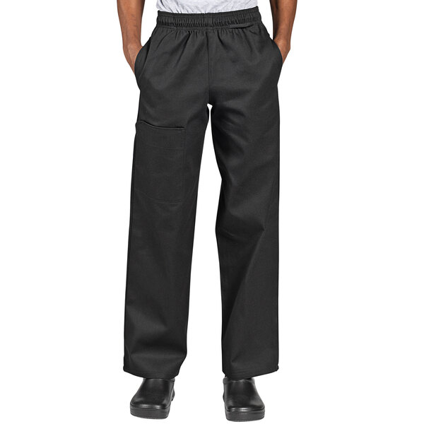 A person wearing Uncommon Cargo black chef pants.