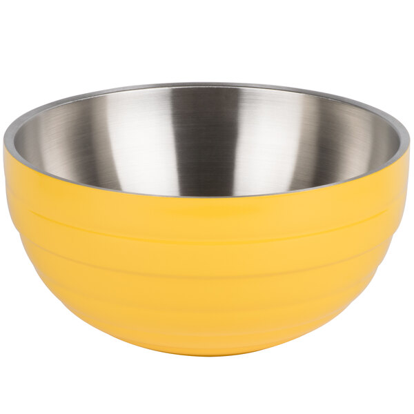 A yellow and silver Vollrath beehive bowl with stainless steel handles.
