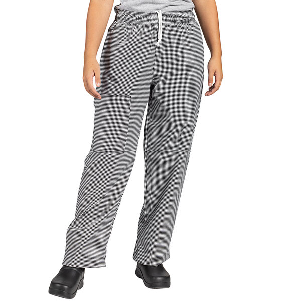 A person wearing Uncommon Chef houndstooth cargo pants in black and white.