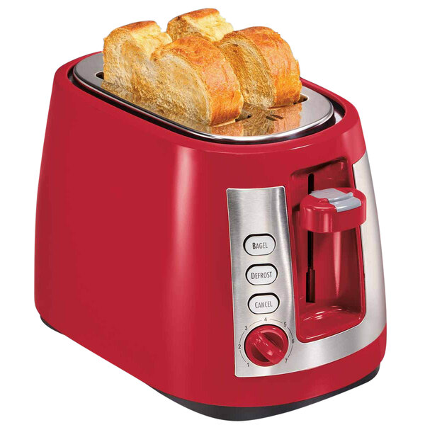 A Hamilton Beach red toaster with slices of bread in it.