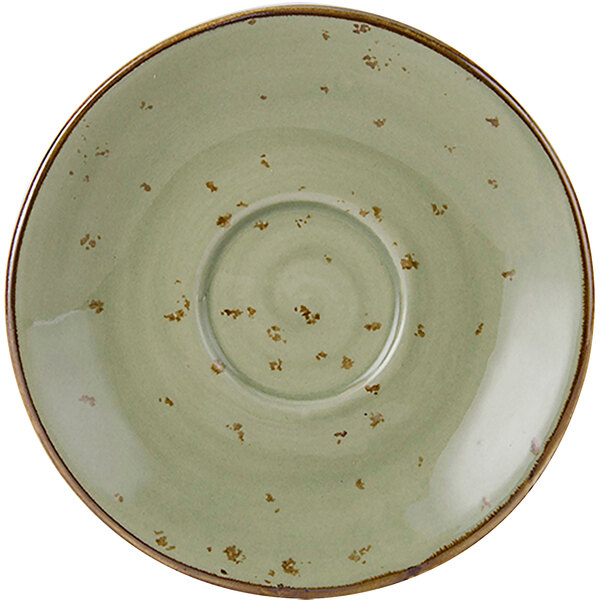 A close-up of a Tuxton Artisan Geode Olive saucer with a speckled design in green and brown.