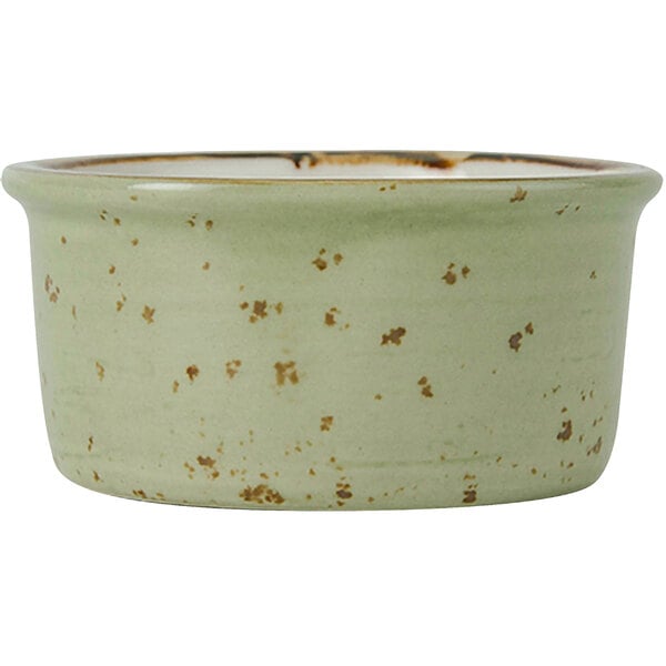 A green Tuxton china ramekin with brown speckles.