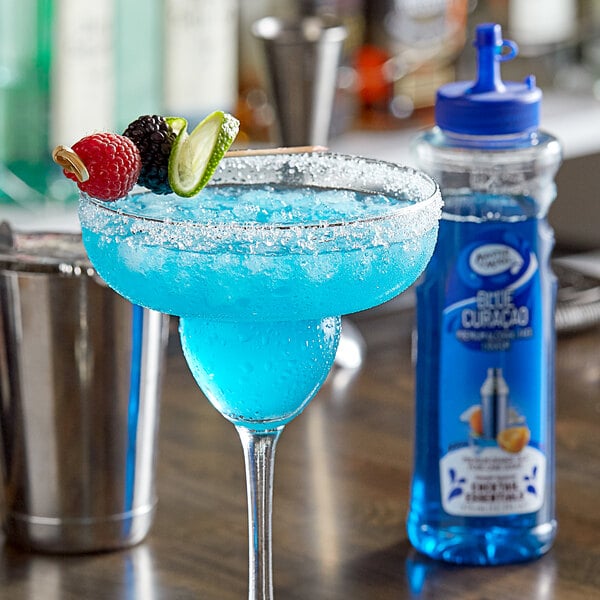 A blue drink in a glass with fruit on top.