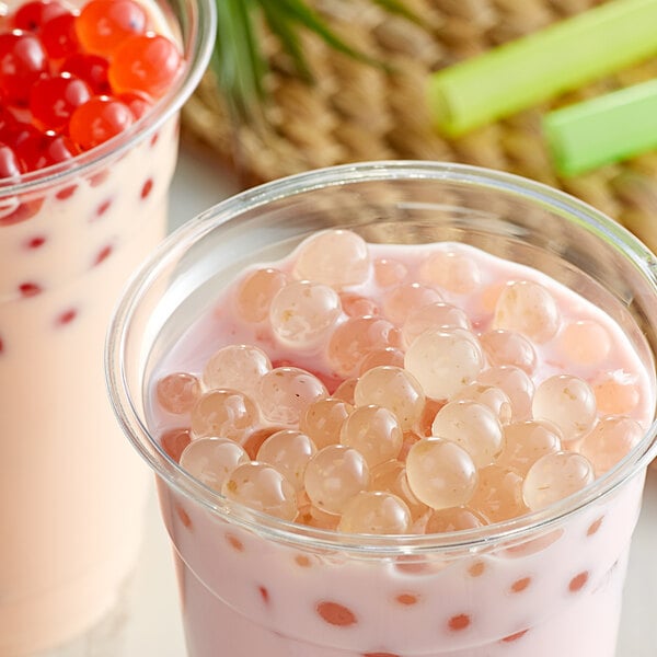 A cup of bubble tea with pink Bossen rose boba.