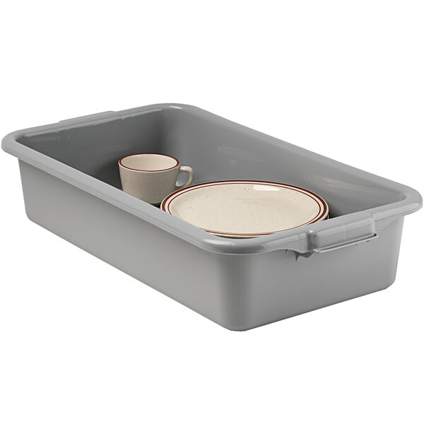A grey plastic container with a white plate and a white cup inside.