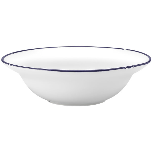 A white Luzerne porcelain pasta bowl with a blue rim.