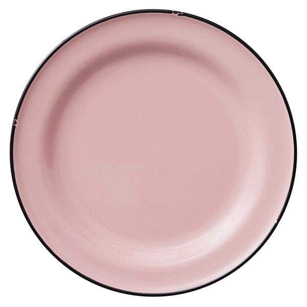 A close-up of a Luzerne pink porcelain plate with a black rim.