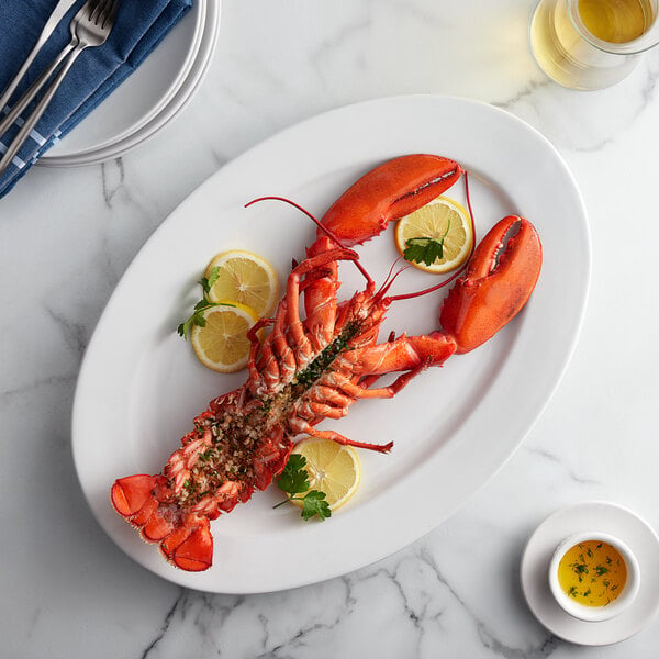 A Boston Lobster Company lobster on a plate with lemon slices and a lobster claw.