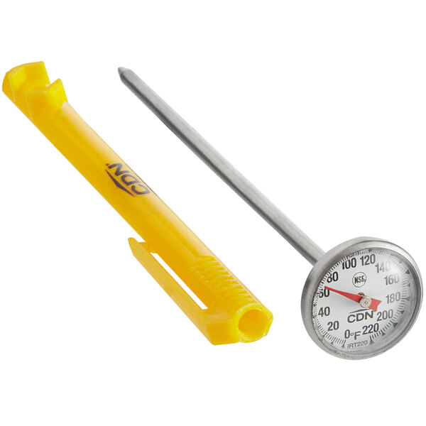 A CDN pocket probe thermometer next to a silver measuring spoon on a counter.