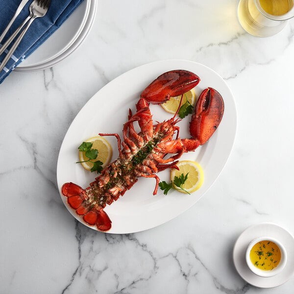 A Boston Lobster Company lobster on a plate with a slice of lemon and a lobster claw.