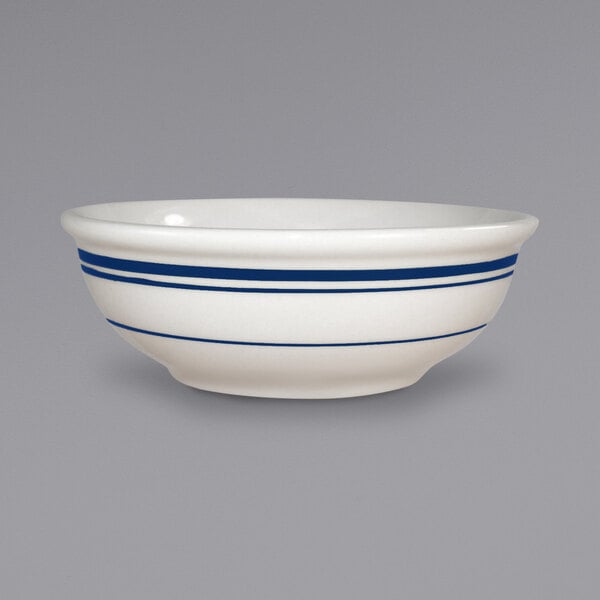 A white International Tableware stoneware nappie bowl with blue bands.