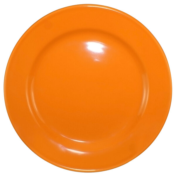 An orange International Tableware Cancun stoneware plate with a white background.