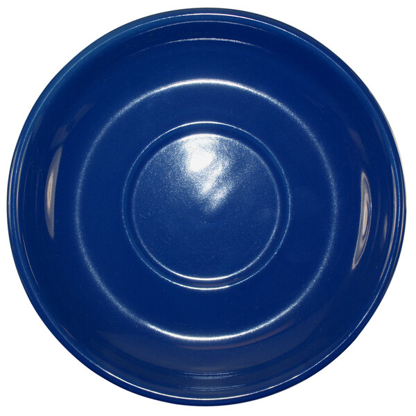 A cobalt blue stoneware saucer with a rim on a white background.
