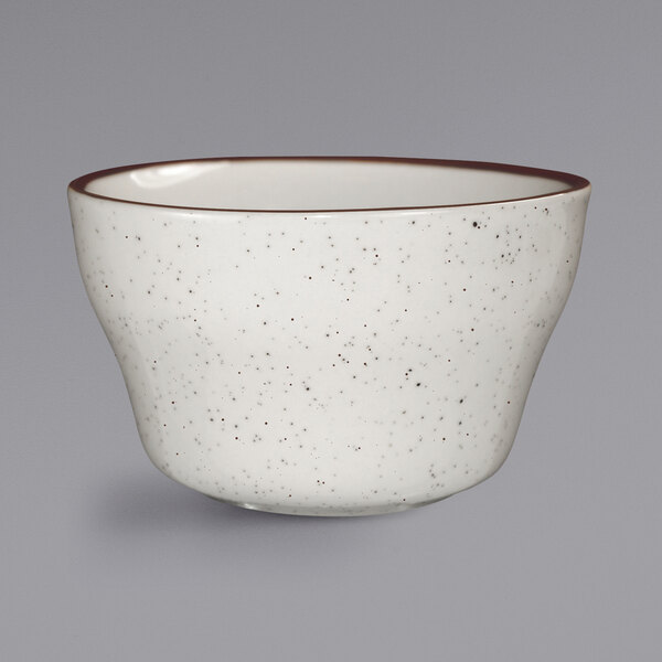 A white bowl with a brown speckled rim.