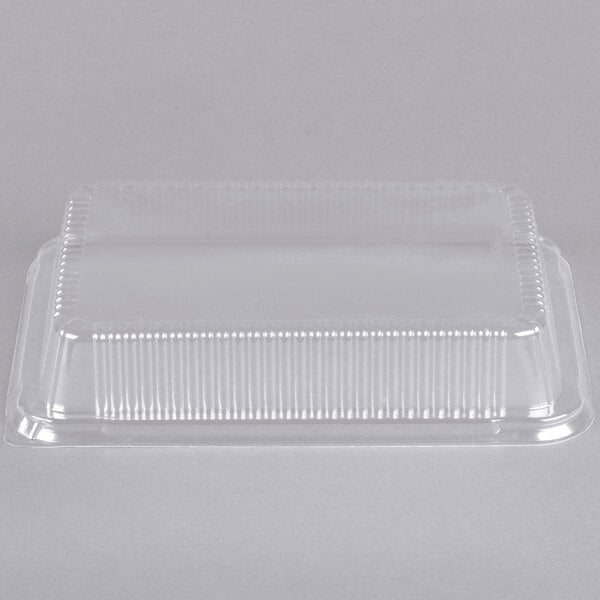 A clear plastic dome lid on a white background.