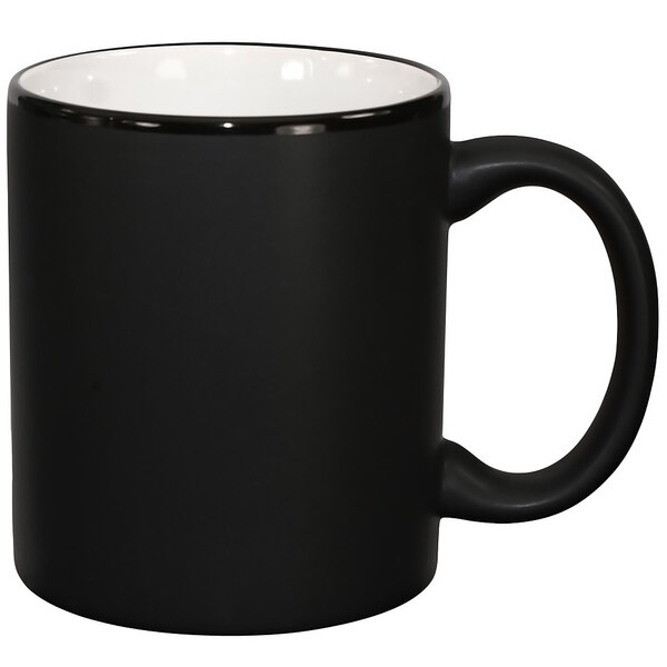 A black stoneware mug with a white rim and handle.
