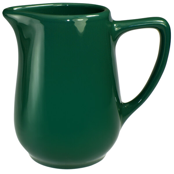 A green International Tableware Cancun creamer with a handle.