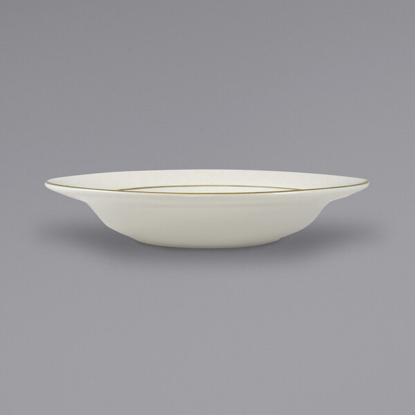 An International Tableware ivory stoneware bowl with a gold rim.