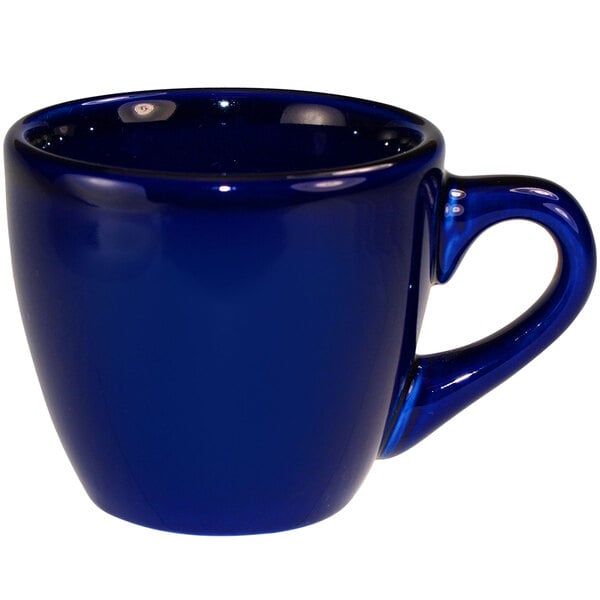 A cobalt blue stoneware espresso cup with a handle.