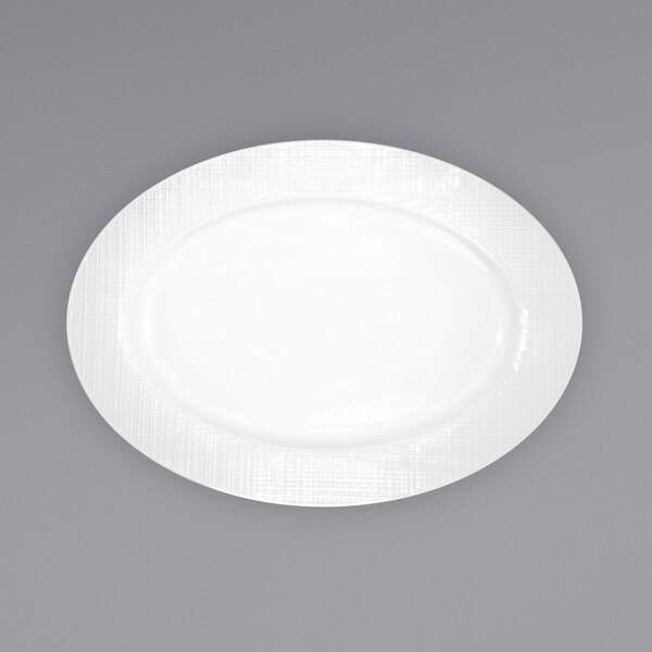 A white porcelain platter with a pattern on the rim.