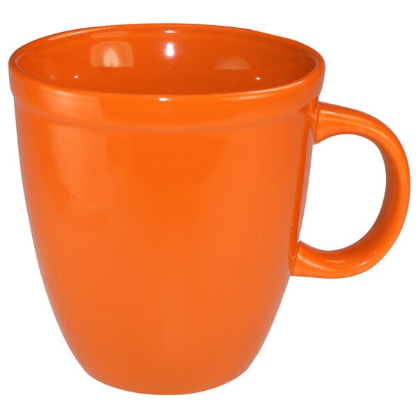 An orange International Tableware stoneware mug with a handle.
