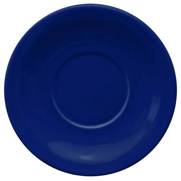 A cobalt blue International Tableware saucer with a circle in the center.