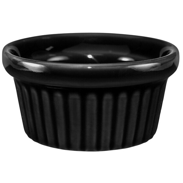 A black stoneware fluted ramekin with a round rim.