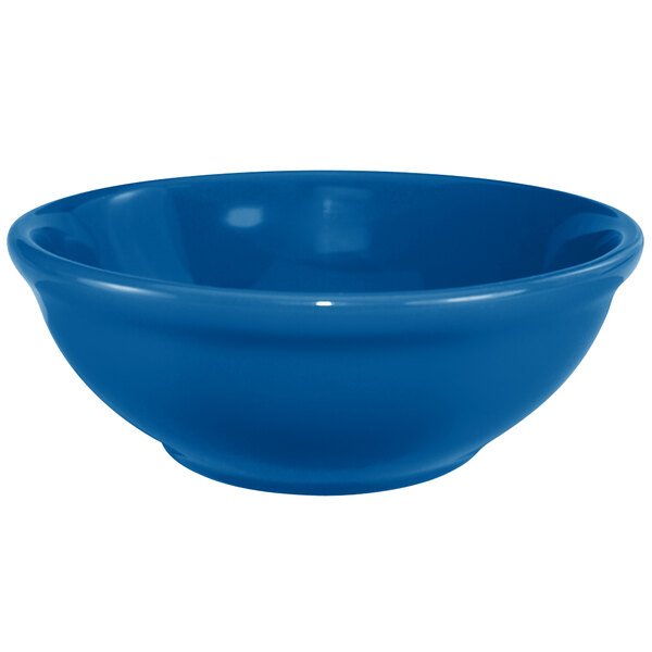 A light blue stoneware bowl with a white rim.