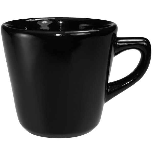 A black International Tableware stoneware tall cup with a handle.