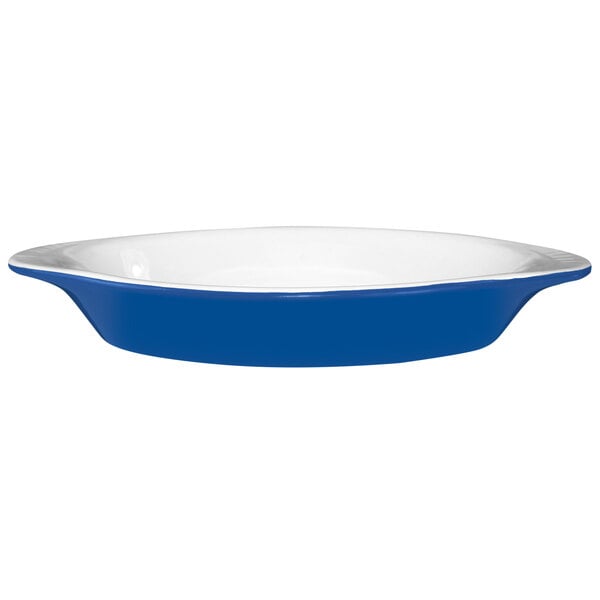 An International Tableware light blue and white two-tone rarebit dish with a white interior and blue exterior.