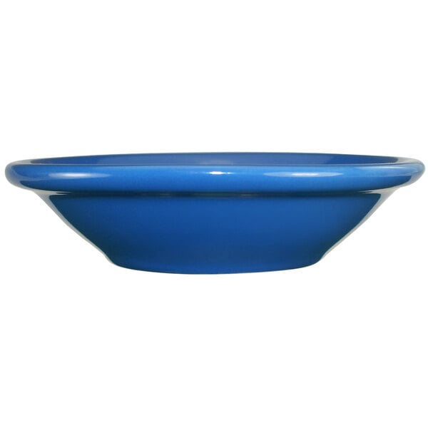 A close-up of an International Tableware light blue stoneware fruit bowl.