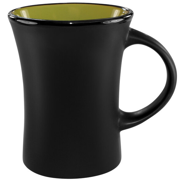 A black stoneware mug with a green rim.