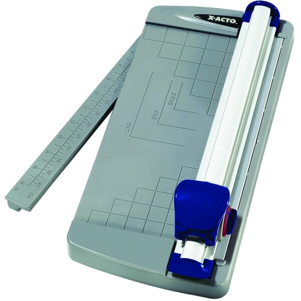 An X-Acto paper cutter with a blue and white plastic base and ruler.
