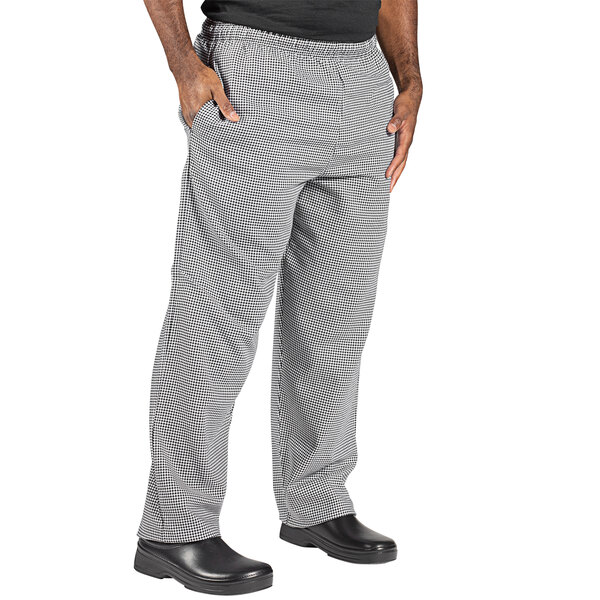 A person wearing black and white Houndstooth chef pants.