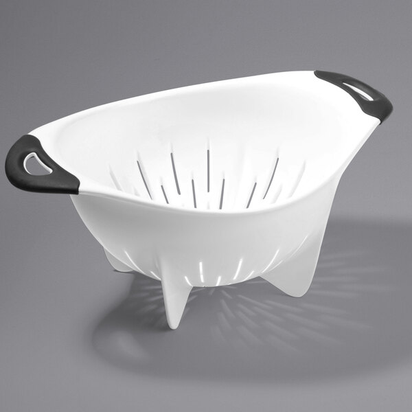 A white colander with black handles.