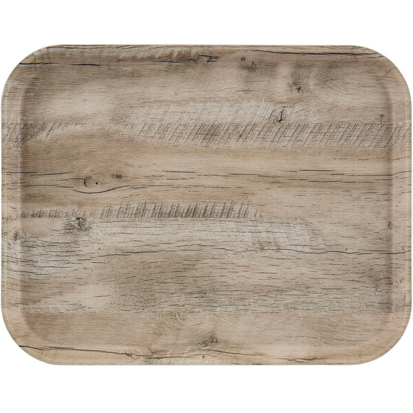 A light olive Cambro fiberglass cafeteria tray with a wood surface.